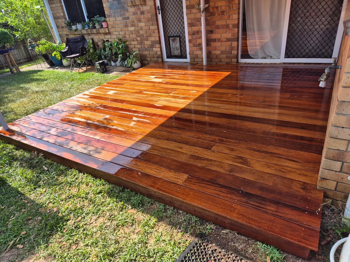 Rich timber deck off the back of a brick home