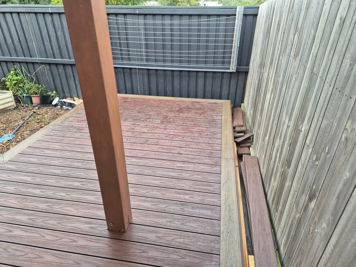 Covered deck against a dark boundary fence