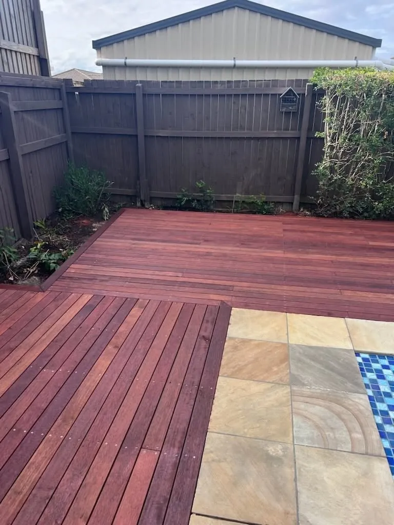 Timber deck meeting sandstone paving